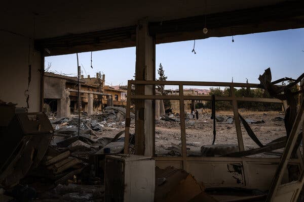 Destruction can be seen from the inside of a badly damaged building.