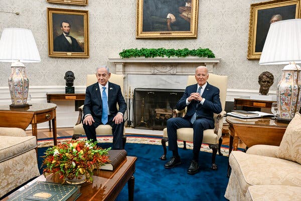 Benjamin Netanyahu, left, sits with his hands on his knees as President Biden clasps his hands in a chair near him.