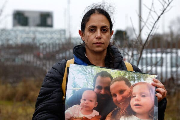 Ofri Bibas-Levy holding a picture of her family.