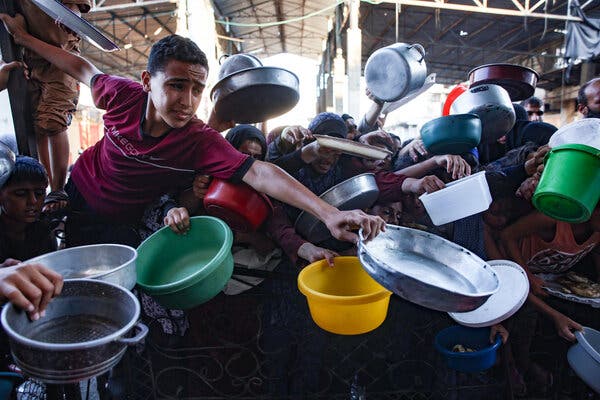 Families wave empty pots and pans as they beg for food.