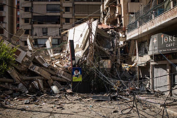 The remnants of a collapsed building on a street.