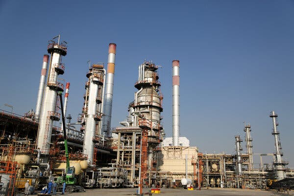 An oil refinery, with extensive piping and vertical stacks. 