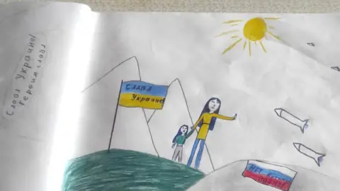 Father of girl who drew anti-war picture freed from Russia jail