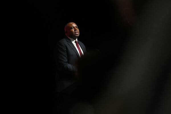 David Lammy, in a navy suit and red tie.