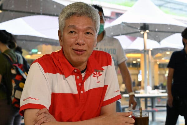 Lee Hsien Yang sits at a table outside at a cafe.