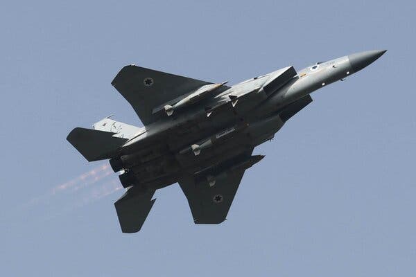 A military jet flying across the sky.