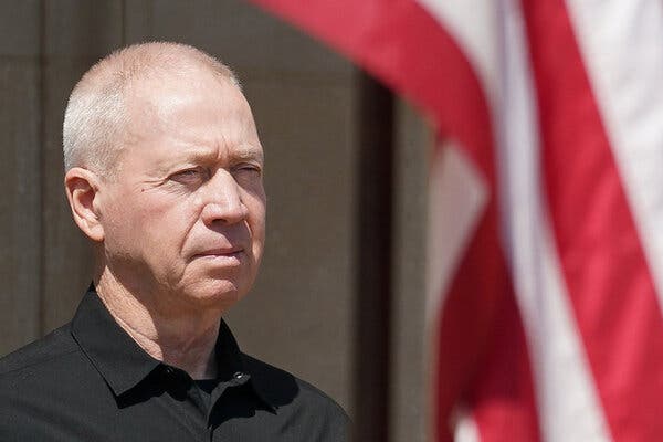 A portrait of Yoav Gallant during a visit in June to Washington. An American flag is in the background. 