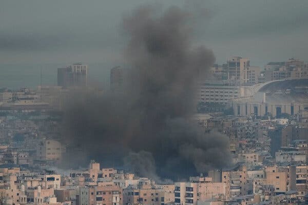 Dark gray smoke over a dense city.