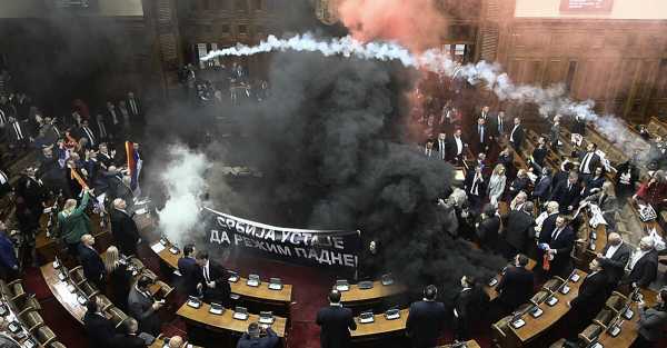 At least three Serbian MPs were injured after smoke bombs and flares were thrown into parliament | INFBusiness.com