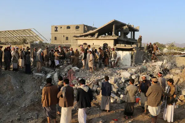 People gathered near the ruins of the destroyed building.