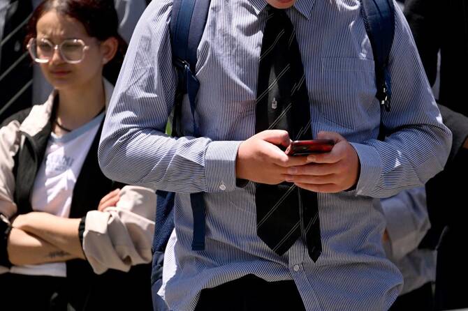 SYDNEY: Australia on Tuesday called on social media platforms to use "minimally invasive" methods to verify the age of users under the world's first ban on teen social media use that take into account artificial intelligence (AI) and behavioural data. Governments and tech companies around the world are closely watching Australia's efforts to become the first country to block under-16s from using social media from December. "eSafety recommends using the most minimally invasive methods available," the internet watchdog said in its guidelines for companies to comply with the law, which passed in November. eSafety Commissioner Julie Inman Grant said social media platforms were not required to carry out blanket age verification as companies could use existing data to reliably determine ages. "We know they have the targeting technology to do this," she said at a news conference. "They can influence us with deadly accuracy when it comes to advertising, and they can certainly do it when we are still children." She added: "Adults shouldn't notice much of a change... it would be unreasonable for platforms to re-verify the age of all users." In July, Grant expanded the ban to Alphabet-owned YouTube after complaints from Meta-owned Facebook, Instagram, Snapchat and TikTok about an earlier decision to exclude the video-sharing site popular with teachers. Google and Meta have not yet responded to requests for comment. In February, eSafety said 95 per cent of 13- to 15-year-olds reported using at least one social media platform since January 2024, but warned the real figures could be much higher. US Communications Secretary Anika Wells called on social media companies to take "reasonable steps" to identify and disable underage accounts, prevent re-registrations and provide users with an accessible complaints process. "We can't control the ocean, but we can control the sharks, and today we're making it clear to the rest of the world how we intend to do that," Wells told reporters. She added that there was no excuse for not complying, as the platforms had the capacity to do so as they were among the largest and best-resourced companies in the world. Amid concerns about the impact on young people's mental health, Australia's ban was passed in November 2024. Companies were given a year to comply and were required to deactivate underage users' accounts on December 10. ($1 = AU$1.4993) Australia wants to introduce 'minimally invasive' age checks as part of teen social media ban | INFBusiness.com