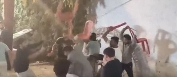 Lawmaker sparks wild wedding fight: Chairs & sticks fly, captured in photo.