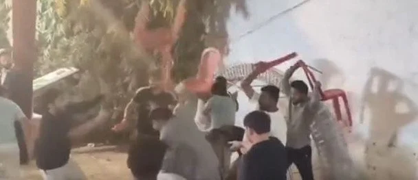 Lawmaker sparks wild wedding fight: Chairs & sticks fly, captured in photo.